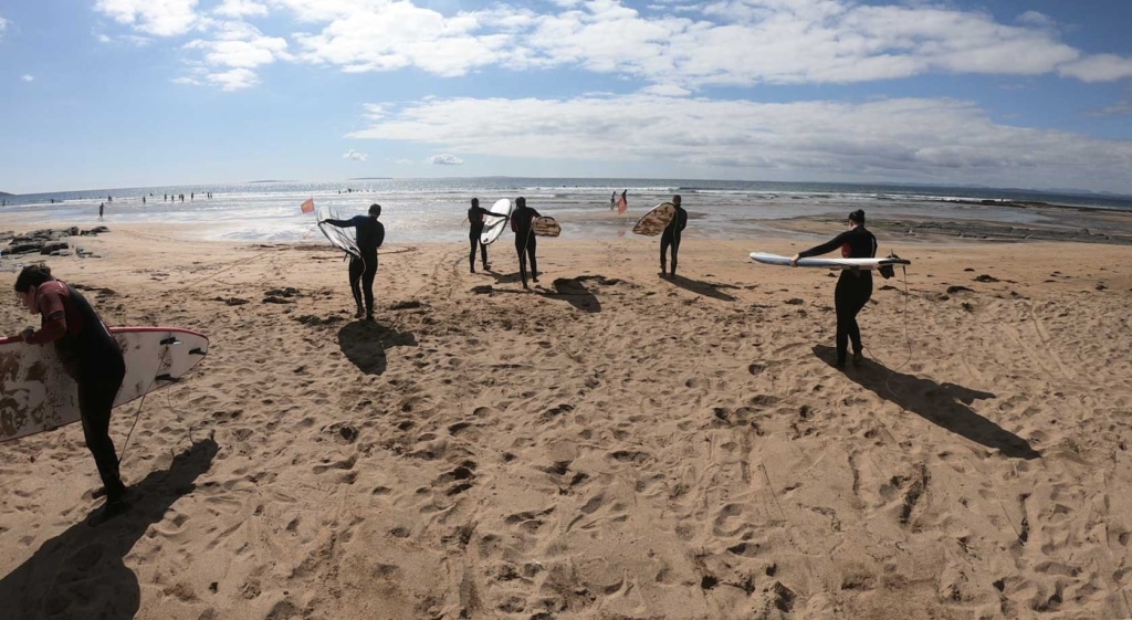 surfing experience - surfers approaching the sea