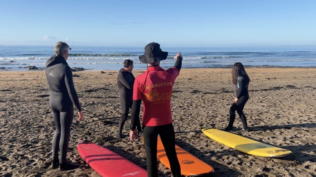 surfers learning from instructor - surf report and lessons